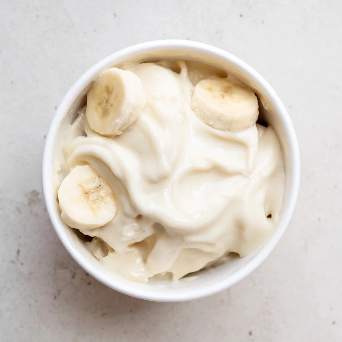 Enjoy perfectly blended 2-Ingredient Banana Ice Cream, a healthy and delicious vegan treat with banana pieces.
