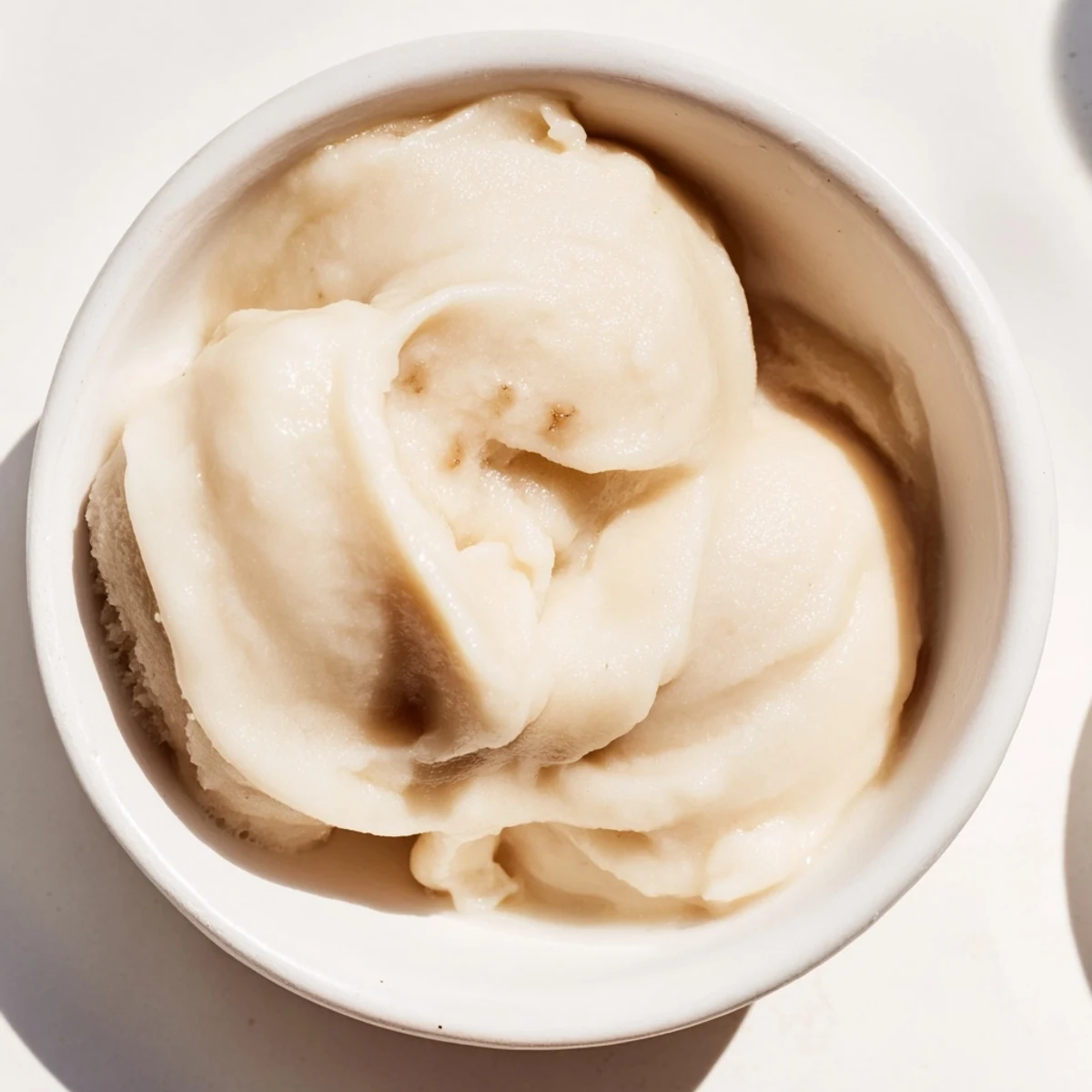 This homemade 2-Ingredient Banana Ice Cream looks ready to serve, a smooth, frozen banana delight.