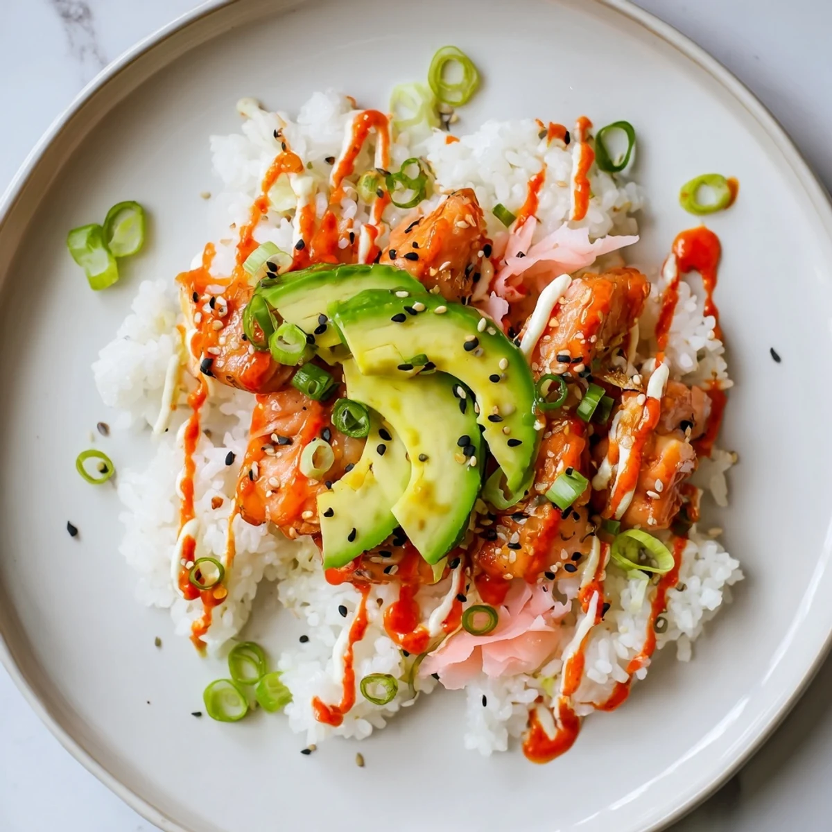 Flaky salmon mixed into seasoned rice, showcasing our Classic Salmon Rice, complete with creamy avocado.