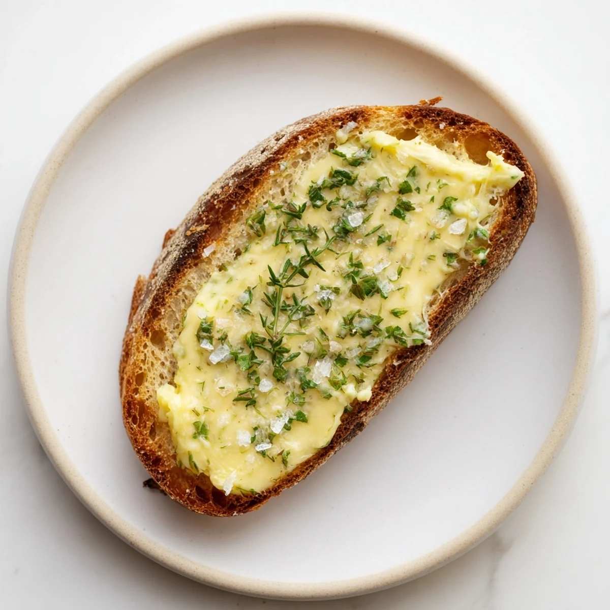 Slices of Herb Butter Toast being served warm, perfect as an appetizer or side with a crisp white wine.  