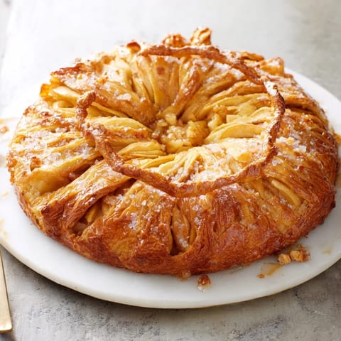 Freshly baked homemade golden apple turnover pastries, perfect for a cozy fall dessert, looking absolutely delicious.