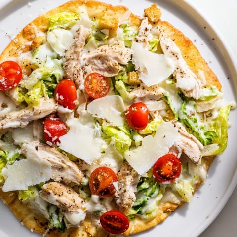 Delicious Chicken Caesar Flatbread with melted mozzarella and perfectly grilled chicken slices.