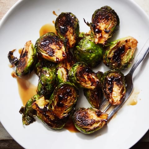 Freshly prepared Roasted Brussels Sprouts With Balsamic, showing caramelized edges and a rich, tangy glaze.