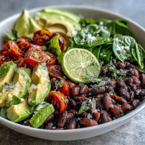 Colorful, hearty plant-based taco bowl loaded with seasoned beans and zesty salsa.