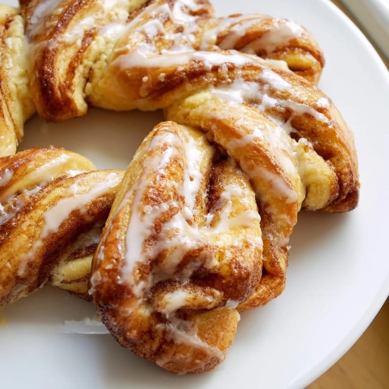 Drizzled Air-Fryer Cinnamon Roll Twists, showing how cinnamon sugar fills each perfect, twisted layer.