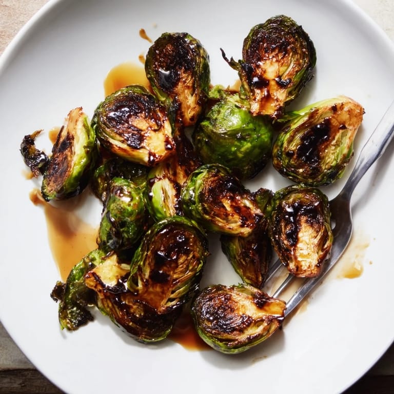 Freshly prepared Roasted Brussels Sprouts With Balsamic, showing caramelized edges and a rich, tangy glaze.