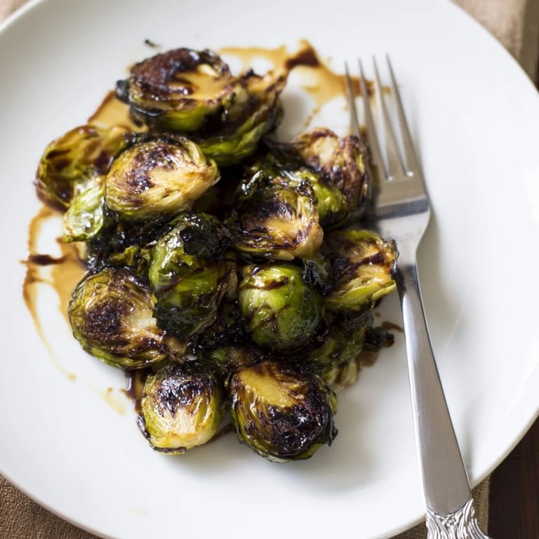 Close-up of crispy Brussels sprouts tossed in olive oil and finished with sweet balsamic vinegar syrup.